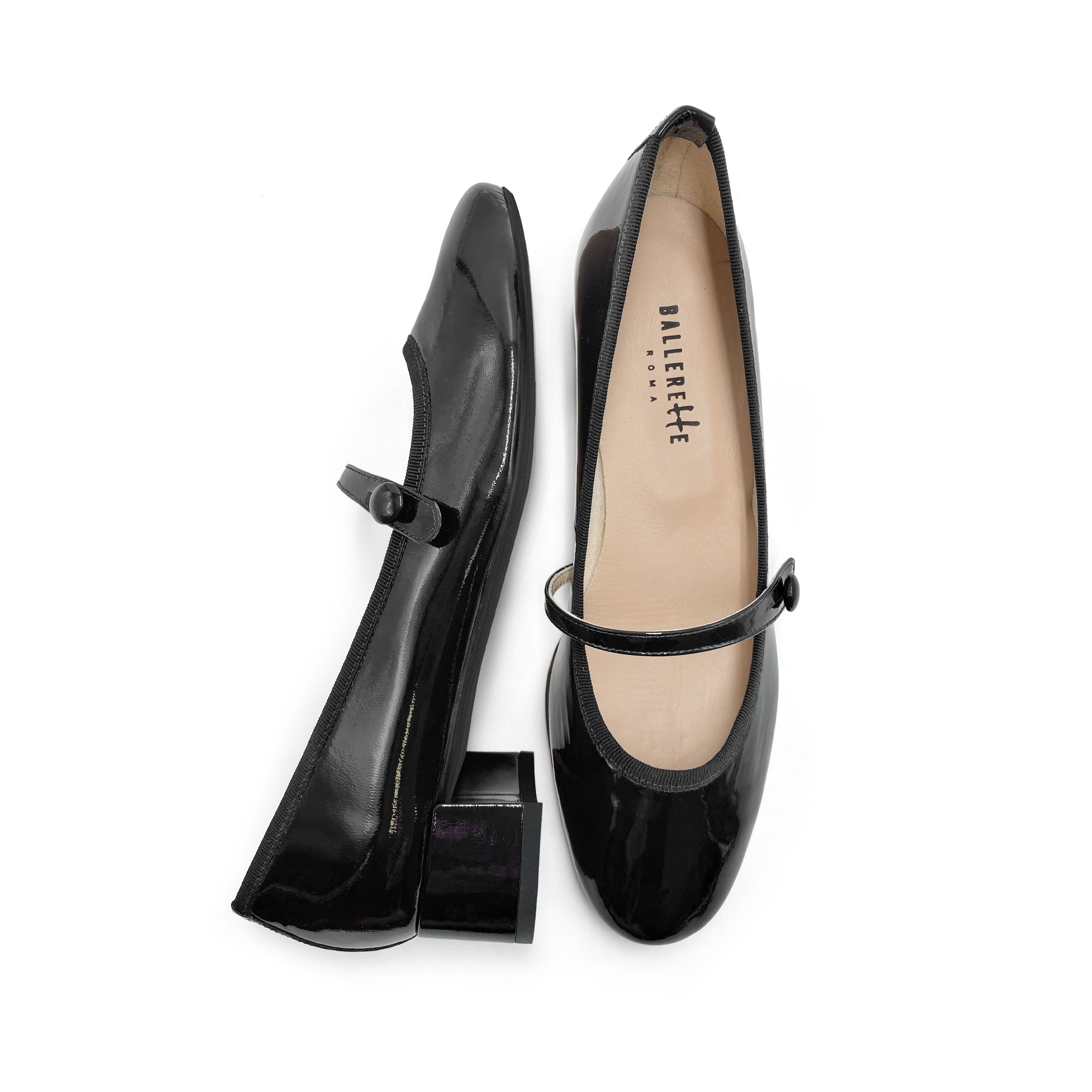 Black patent leather ballet flats with strap and heel