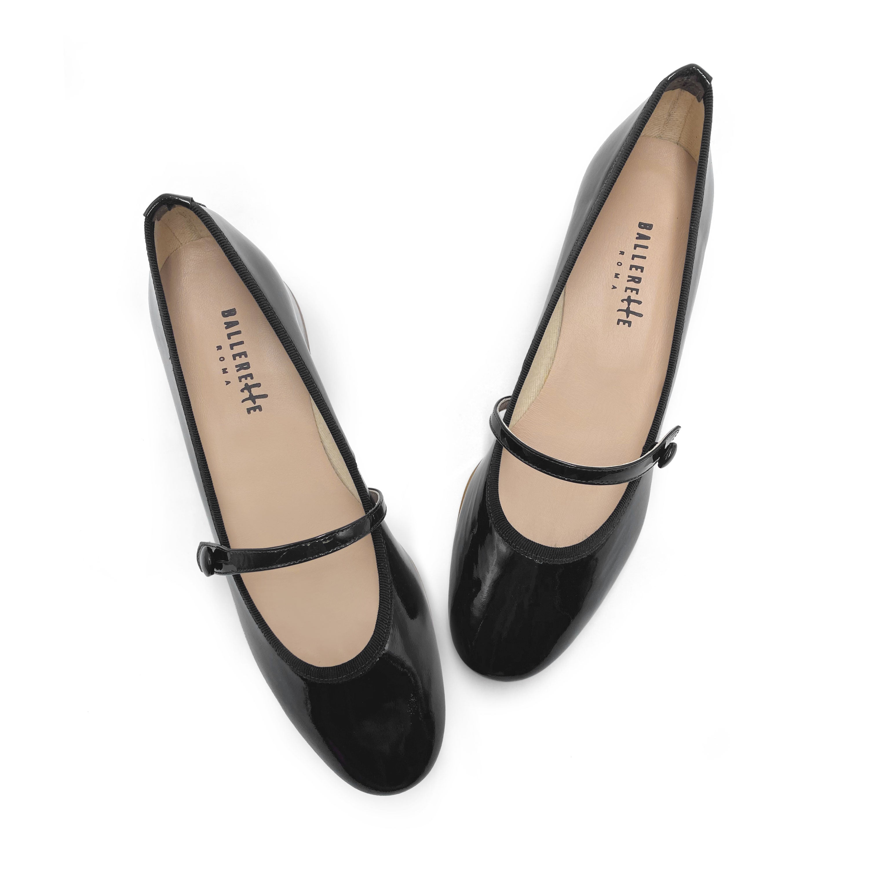 Black patent leather ballet flats with strap and heel