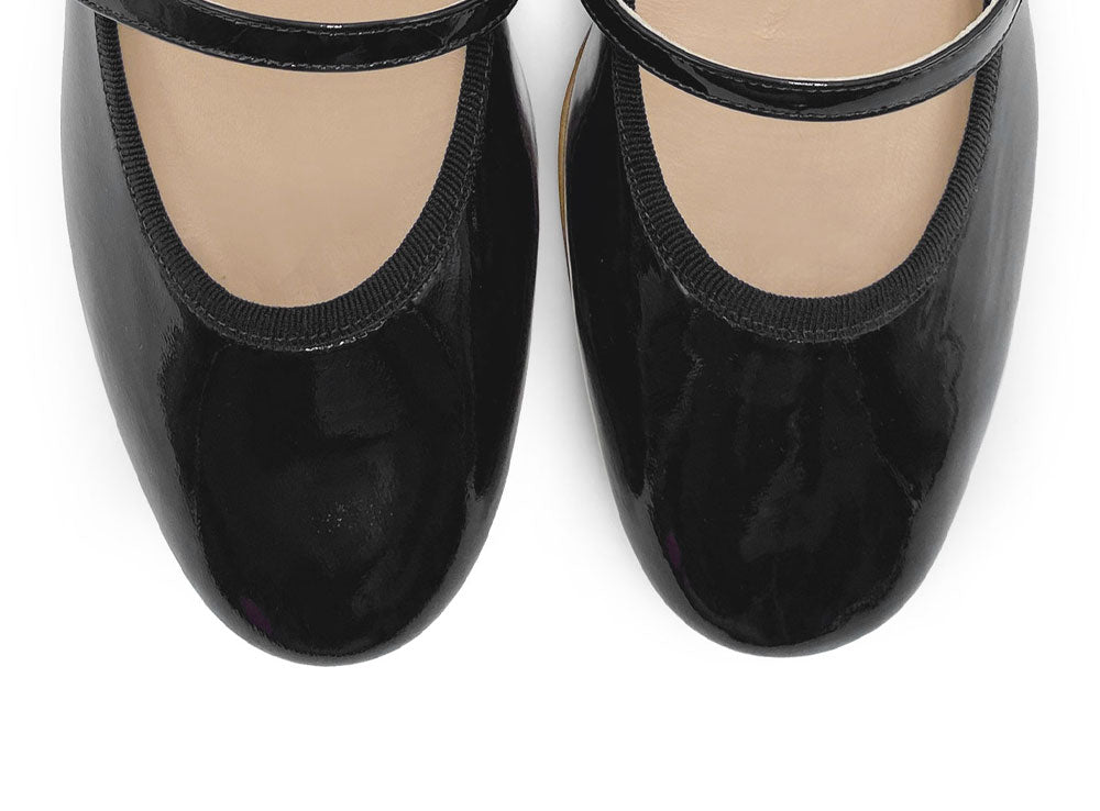 Black patent leather ballet flats with strap and heel