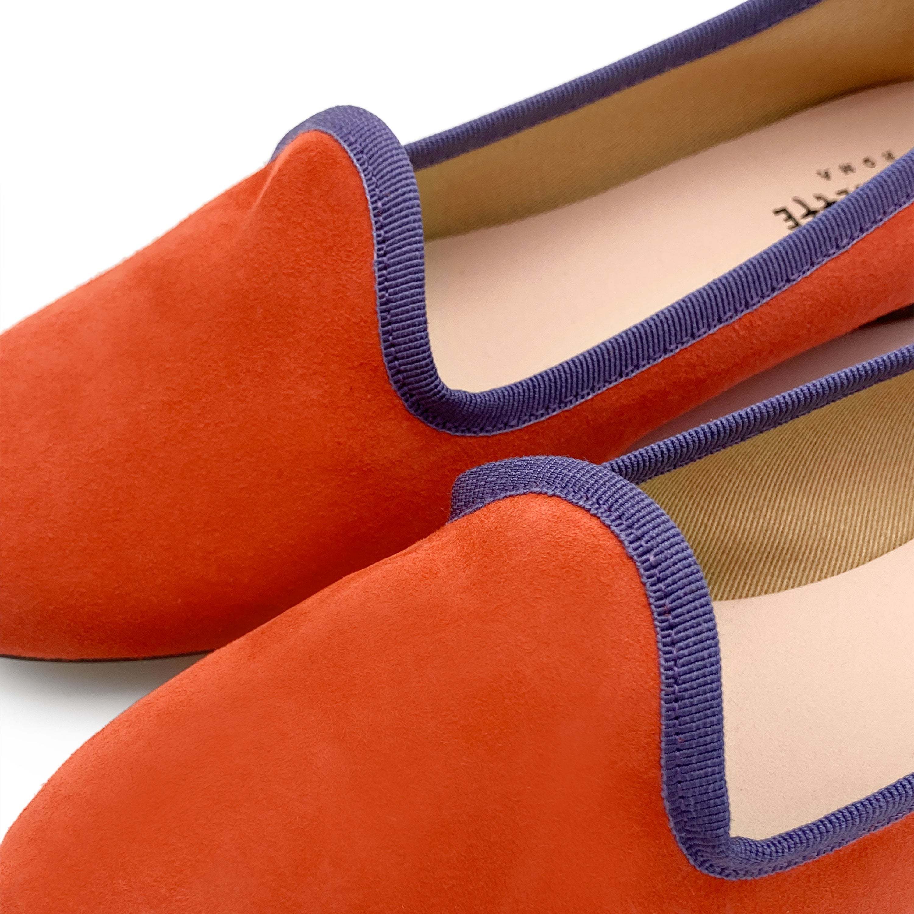 Women's orange suede loafers with purple details
