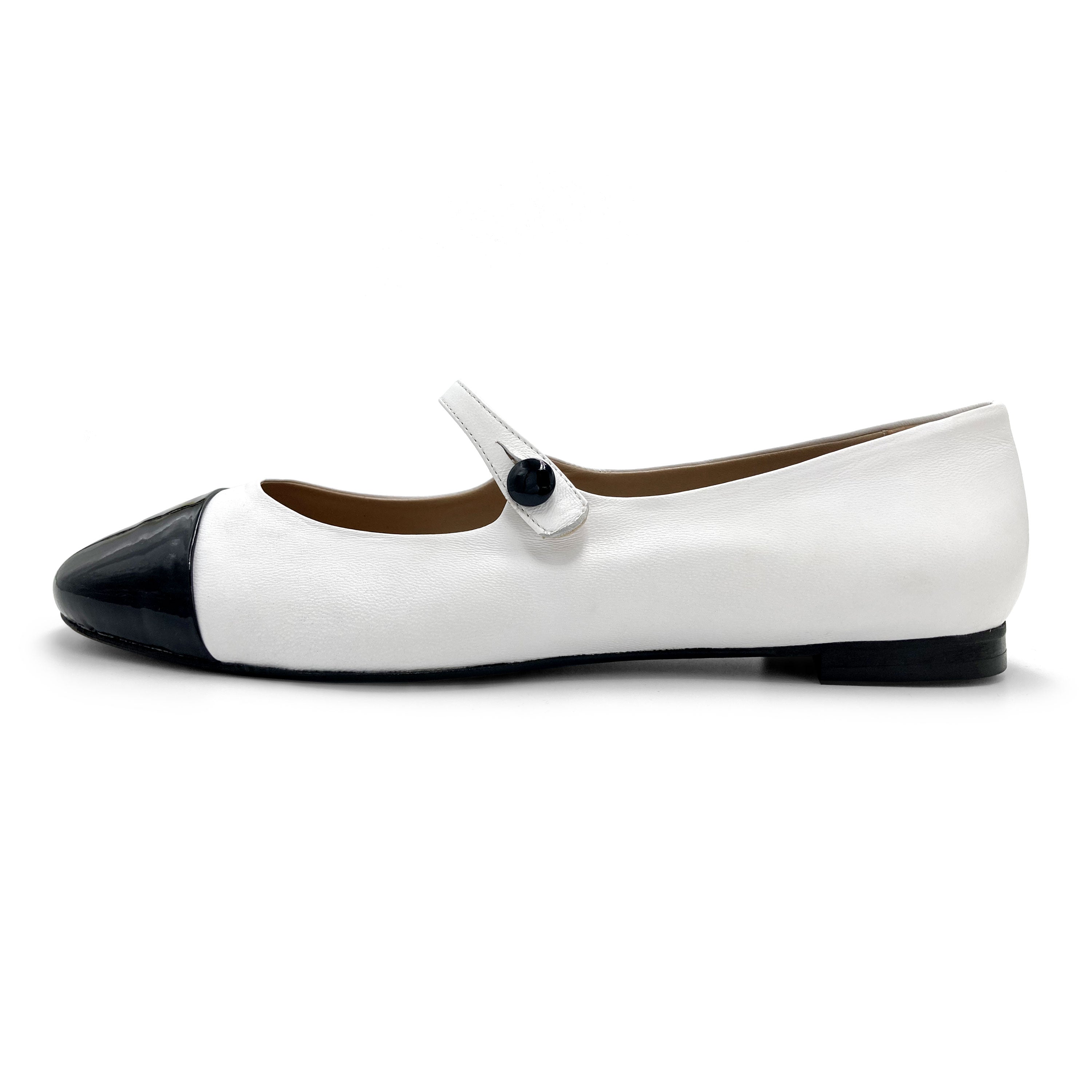 White ballet flats with black patent toe and strap