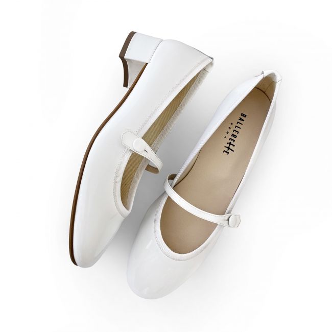 White patent leather ballet flats with strap and heel